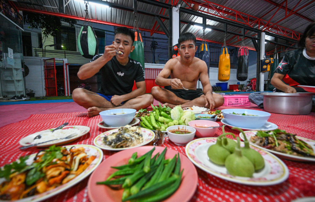 Combat athletes eating at the gym